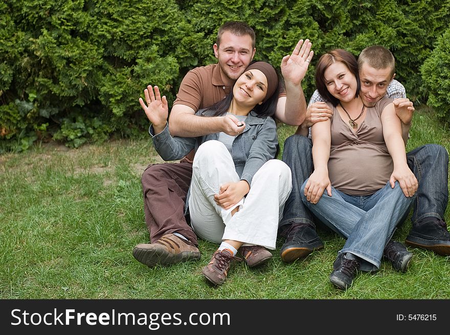 Group of happy friends on green grass