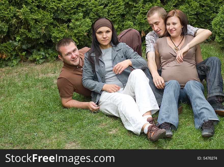 Group of happy friends on green grass