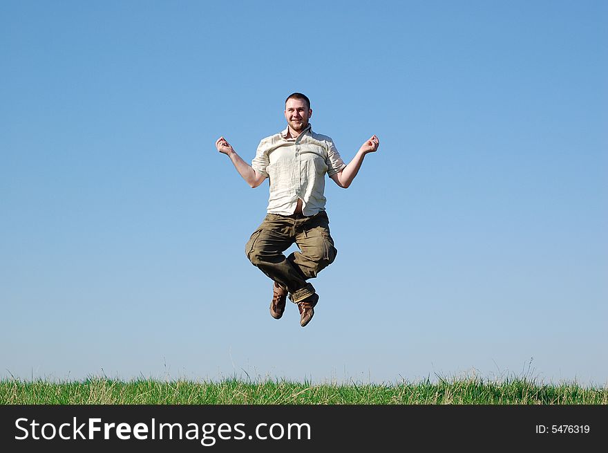 Happy man jumping on green meadow. Happy man jumping on green meadow