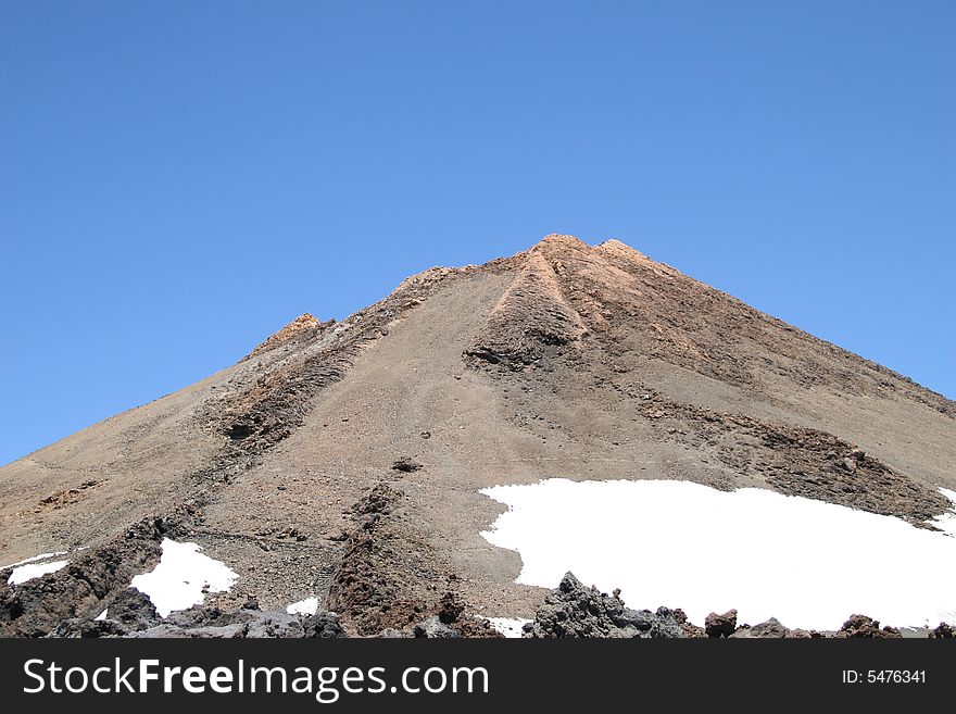 Peak of the mount teide with residual snowfields