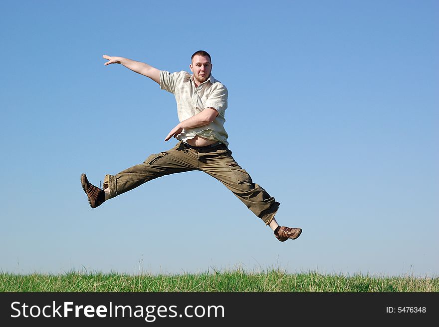 Happy man jumping on green meadow. Happy man jumping on green meadow