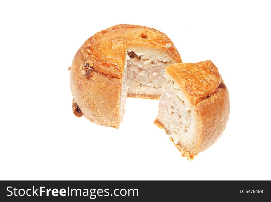 Cut pork pie isolated on a white background