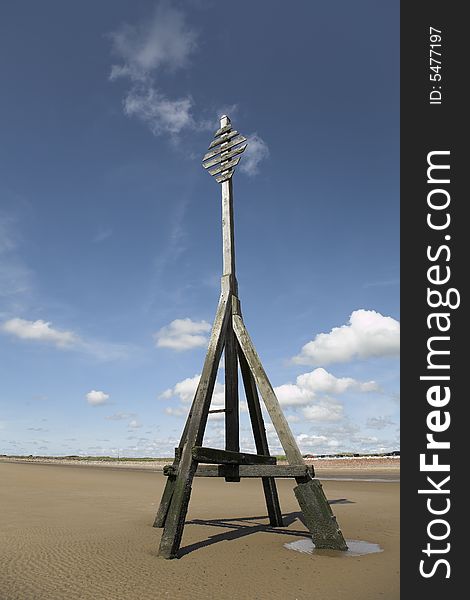 Beach scene with timber Crosby Navigation Marker against blue sky. Beach scene with timber Crosby Navigation Marker against blue sky