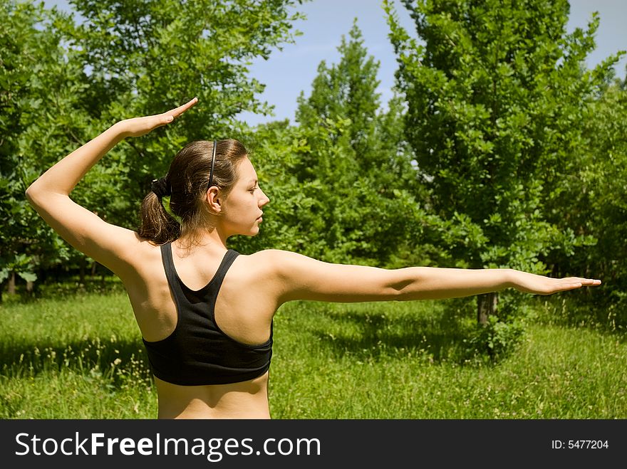 Sporty girl making yoga outdoors