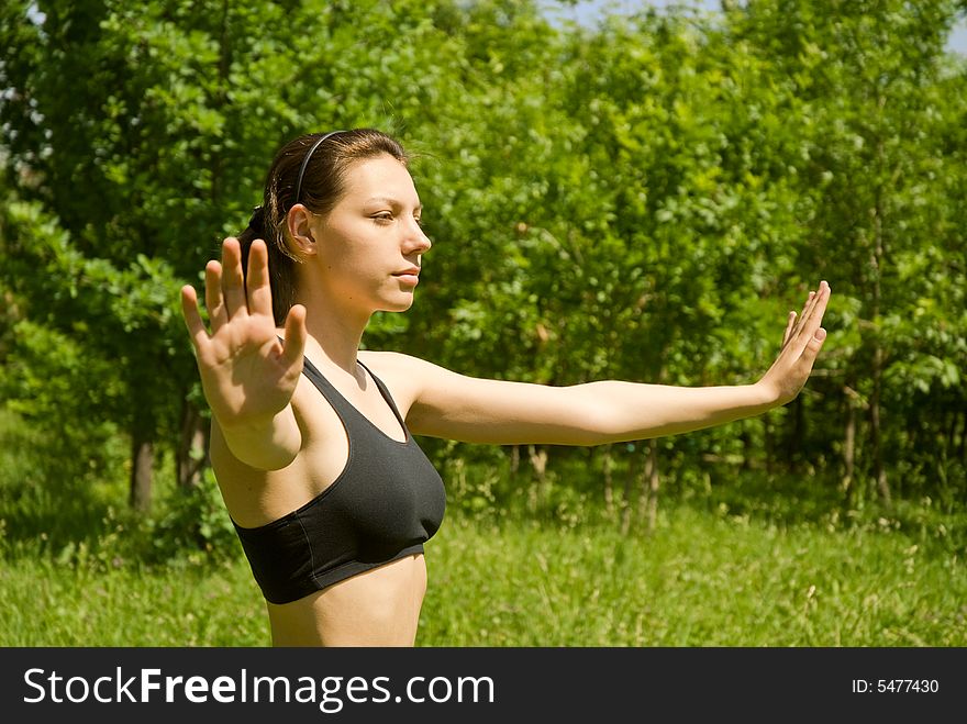 Sporty girl making yoga outdoors