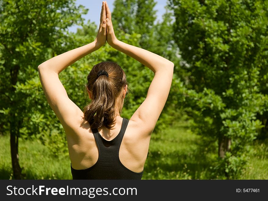 Sporty girl making yoga outdoors