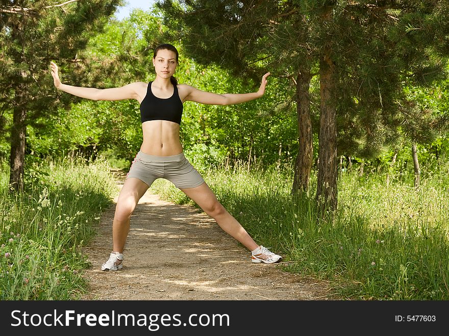 Young attractive woman making exercise alone in the park in a sunny day. Young attractive woman making exercise alone in the park in a sunny day