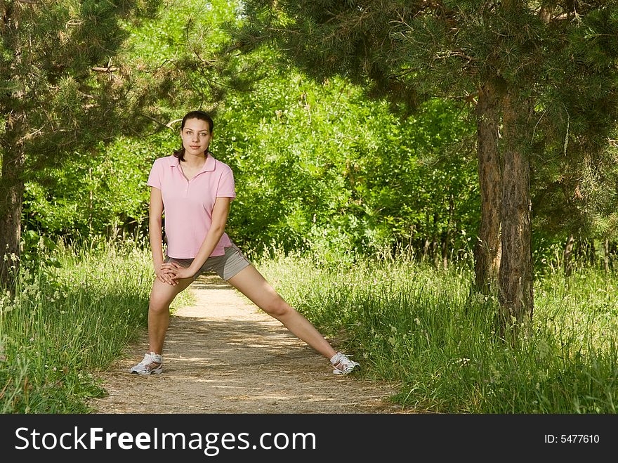 Young attractive woman making exercise alone in the park in a sunny day. Young attractive woman making exercise alone in the park in a sunny day