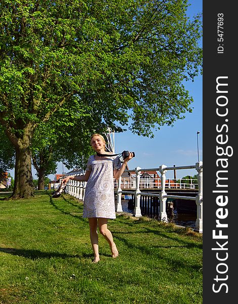 Happy Woman With A Photo Camera Outdoor