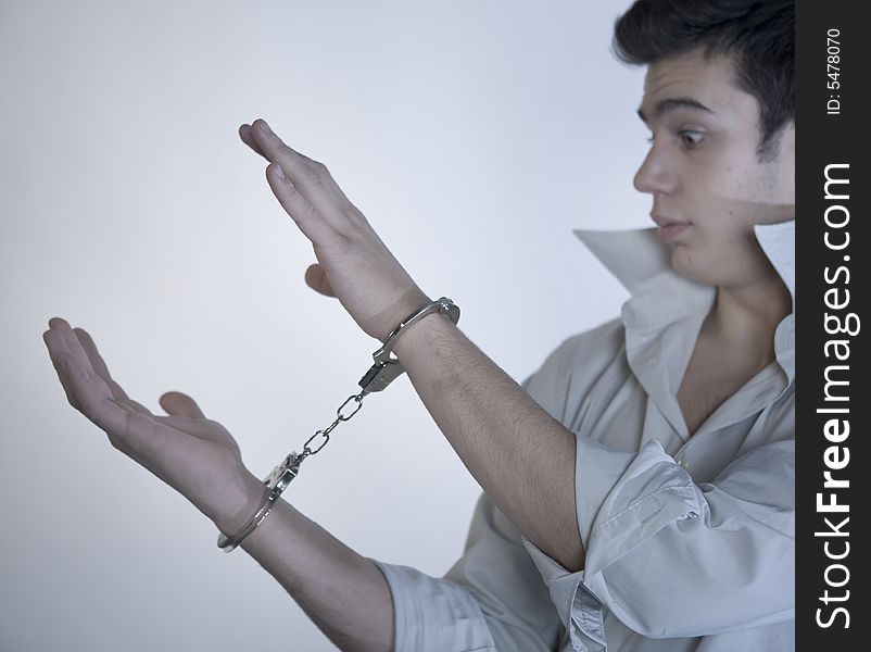 Young boy wrists with handcuffs. Young boy wrists with handcuffs