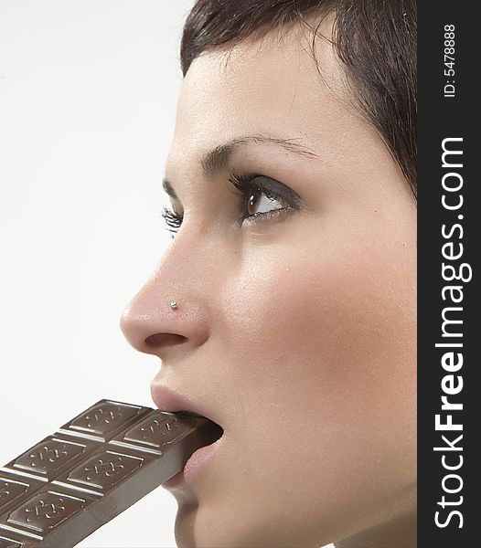 Beautiful girl eating some chocolate. Beautiful girl eating some chocolate