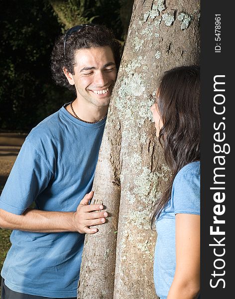 Couple Leaning Against A Tree - Vertical