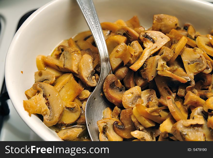 A Plate of oily mushrooms after the meal. A Plate of oily mushrooms after the meal