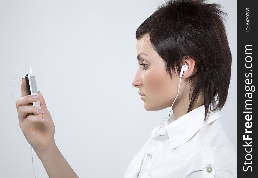 Girl with Mp3-player listening to the music