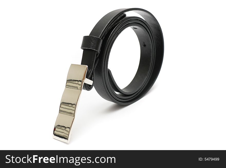 A rolled up black color trousers belt stand on white background. A rolled up black color trousers belt stand on white background.