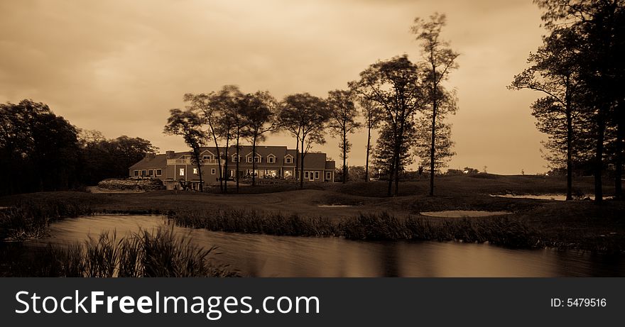 This is a shot looking up from the 18th hole at the club house of a golf course.