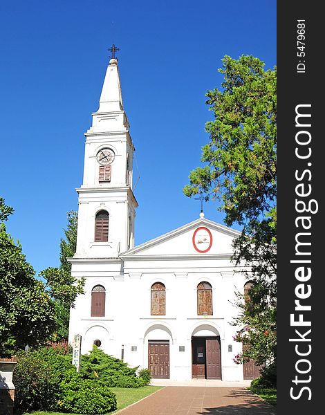 A small town  catholic church with blue sky. A small town  catholic church with blue sky