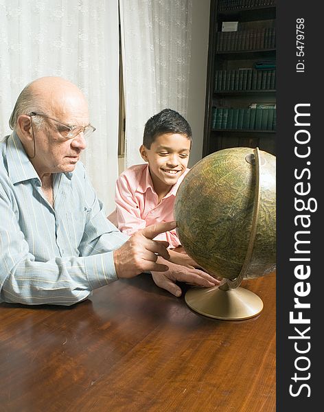 Grandfather and grandson sitting at the table