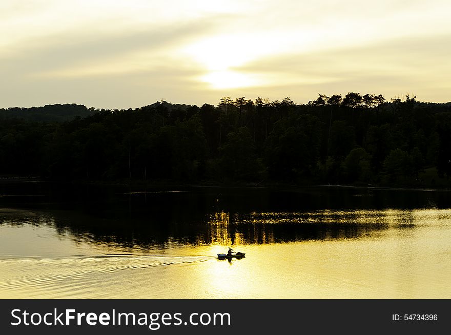 Kayaker On The Lake At Sunset