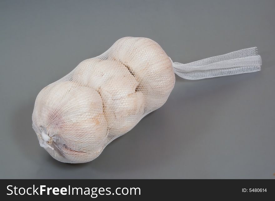 Three Garlic Bulbs In A Net