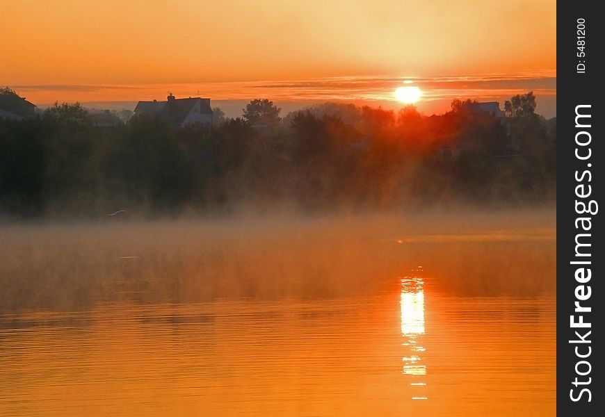 Sun path on a dawn lake