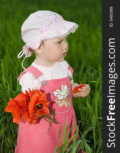 An image of baby-girl amongst field with red flowers. An image of baby-girl amongst field with red flowers
