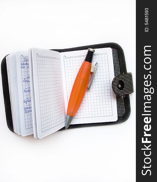 A photograph of ballpoint and writing-pad. A photograph of ballpoint and writing-pad