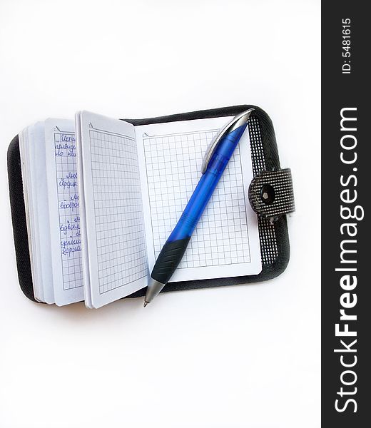 A photograph of ballpoint and writing-pad. A photograph of ballpoint and writing-pad