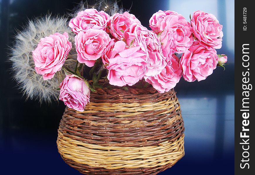 Beautiful pink flowers in wood vase is a perfect gift