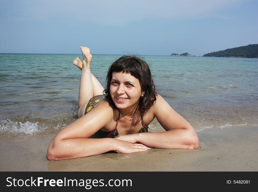 Happy young girl in bikini relaxing on the beach on Thassos island. Happy young girl in bikini relaxing on the beach on Thassos island