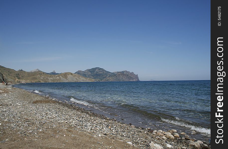 Deserted coast and mountains along beach. Deserted coast and mountains along beach
