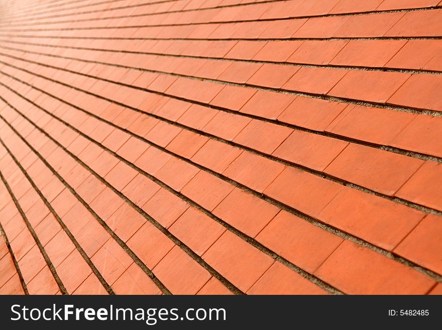 Background of a diagonal red orange brick wall. Background of a diagonal red orange brick wall