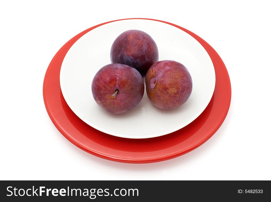 Plums on a plate isolated with two paths: for plums and for plate