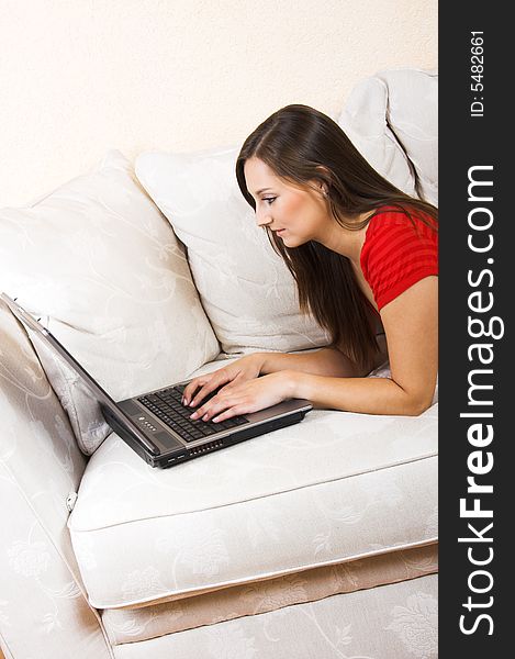 Woman with a laptop on a lounge