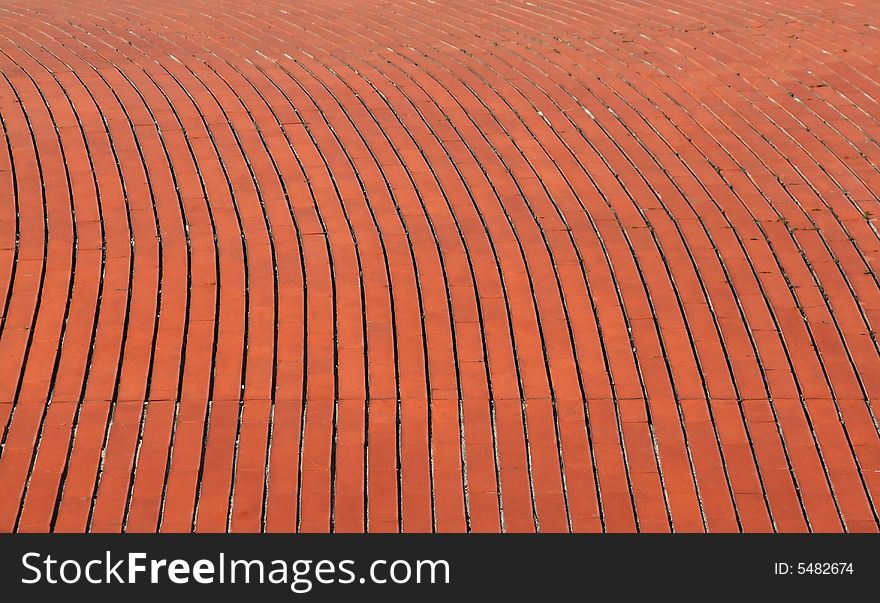 Background of a curve red orange brick wall. Background of a curve red orange brick wall