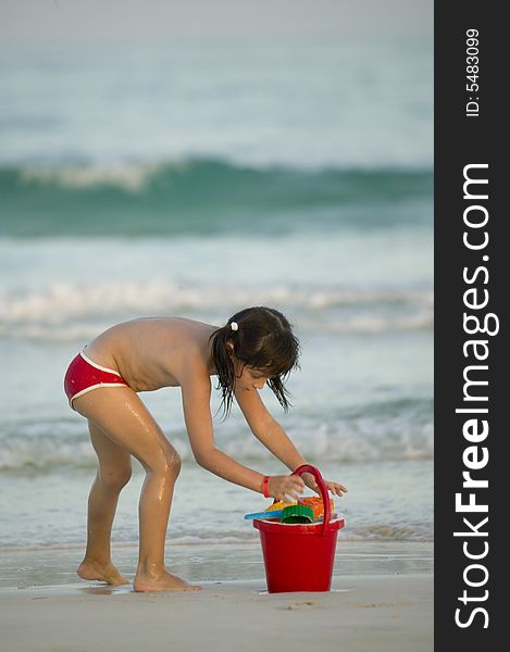 Little child play with sand on beach