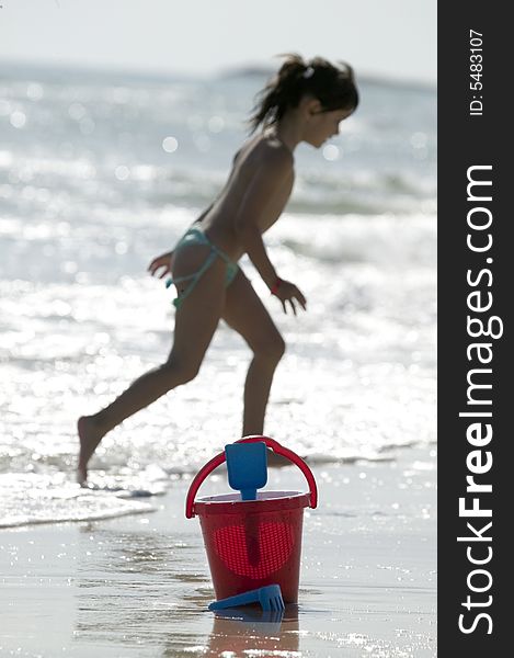 Little child play with sand on beach