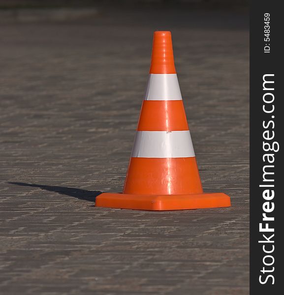 Striped restrictive cone on a road
