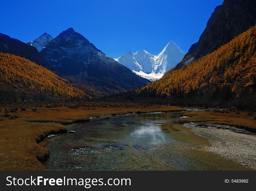 Plateau snow-capped mountains with river, in the yading scenic scenic spots, daochen ,china. Plateau snow-capped mountains with river, in the yading scenic scenic spots, daochen ,china