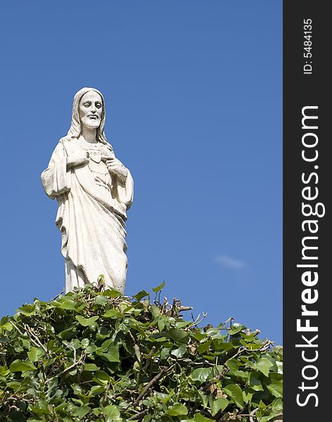 Jesus's white statue on a background of the blue sky