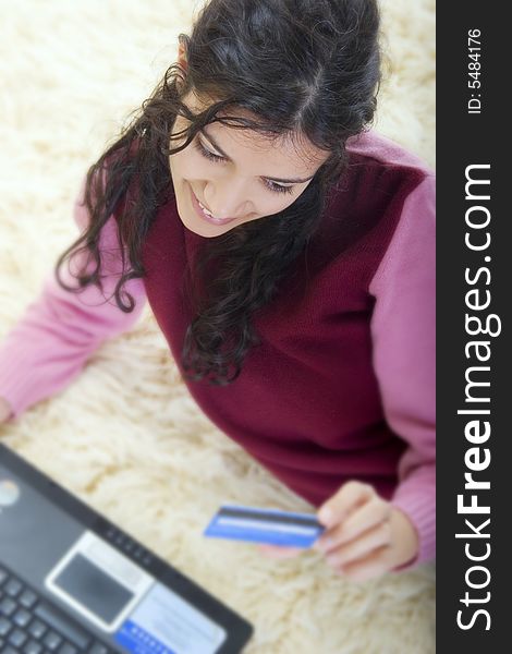 Young woman shopping online with credit card and laptop computer