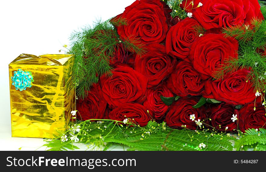 Red roses with a gift on a whiteness