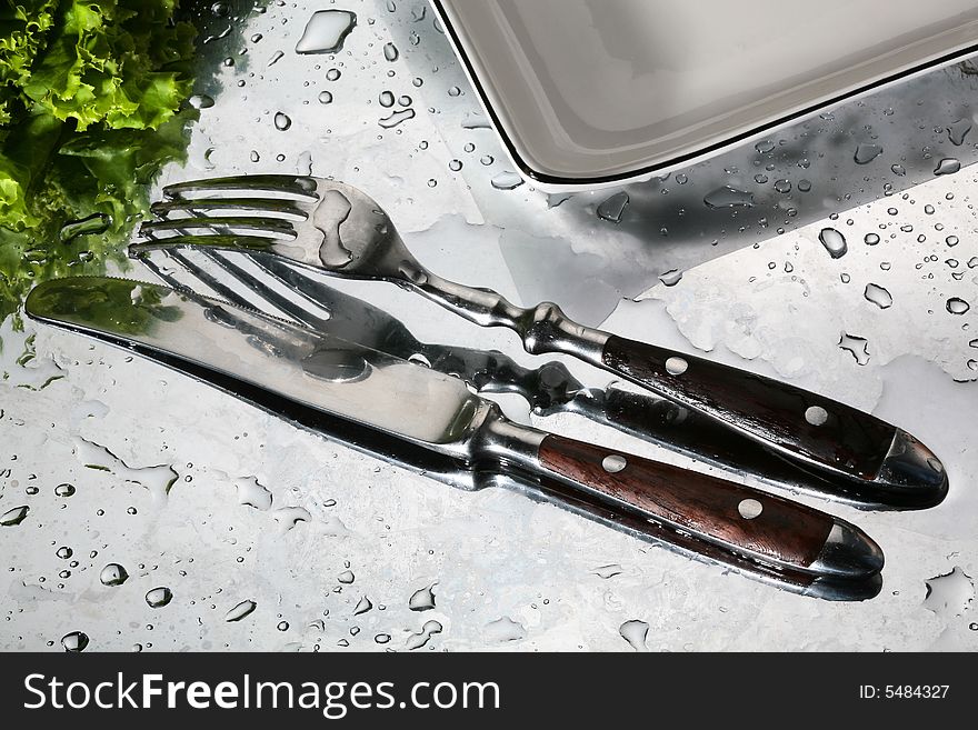 Knife and plug on a wet table. Knife and plug on a wet table