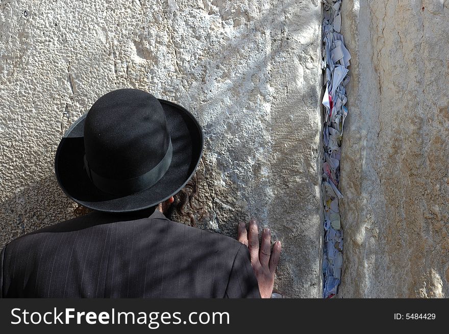 Orthodox man prayers at Western wall of Jerusalem