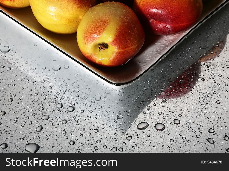Fruit on a plate with drops of water