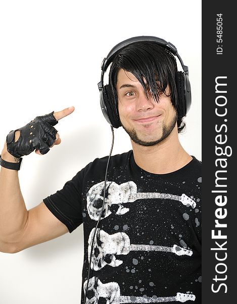 Portrait of young trendy hispanic male pointing to headphones - isolated. Portrait of young trendy hispanic male pointing to headphones - isolated