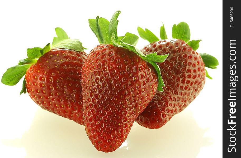 Close up shot of three ripe strawberry over white background