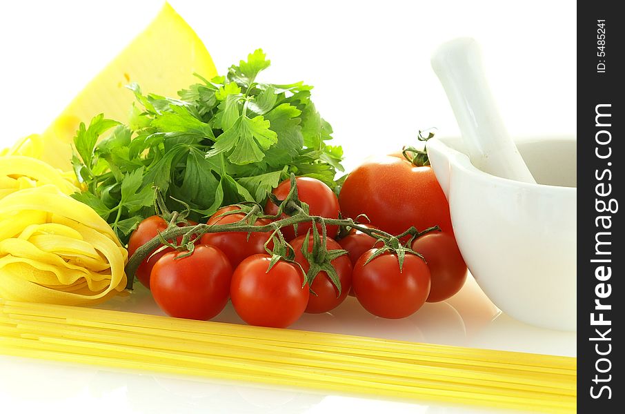Fresh ripe tomatoes with parsley, cheese and pasta over white background