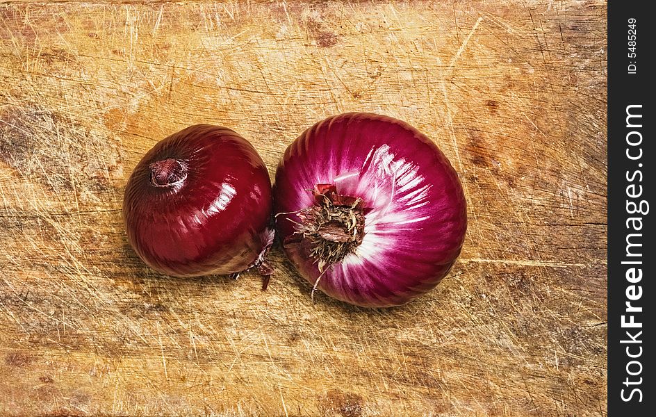 Spanish red onions on wood background. Spanish red onions on wood background.