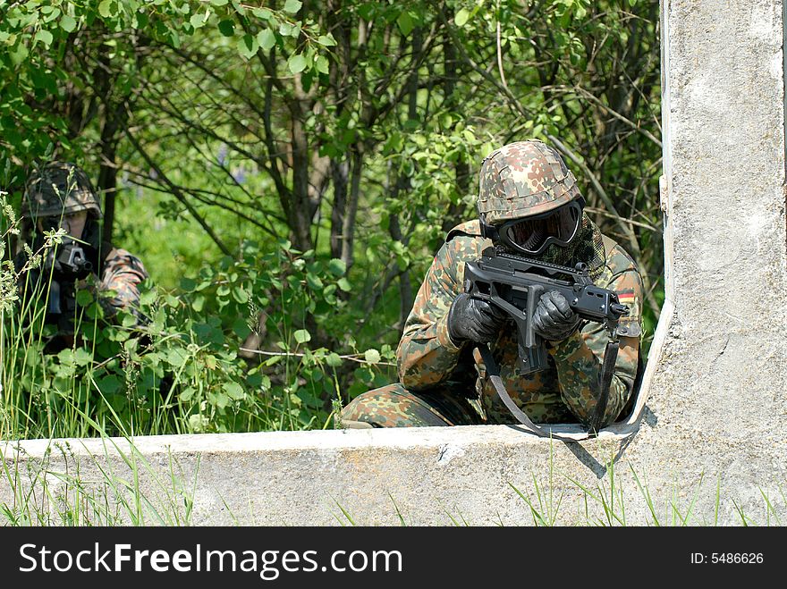 The soldier in protective clothes with weapon. The soldier in protective clothes with weapon